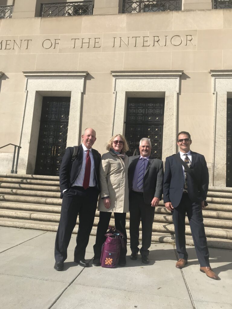 People gathered in front of the Department of the Interior