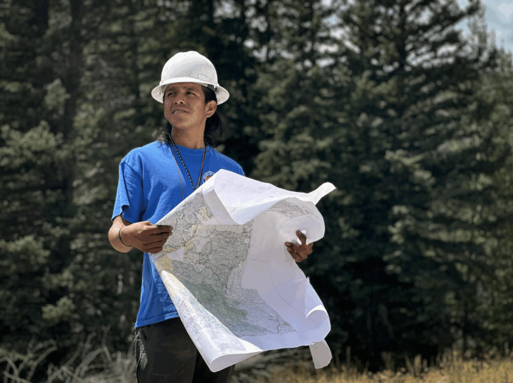Rocky Mountain Youth Corp Seed Crew Member Jude Ansala, with the Zia Pueblo tribe identifies trees with superior seeds used to reforest areas impacted by fire.